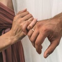 Couple holding hands in the aftermath of infidelity thinking about their future after rebuilding trust with the affair recovery program: It's Okay To Stay