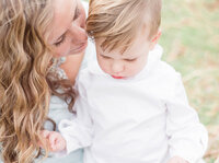 Mother kisses her toddler during Family Portraits in Charleston, SC.