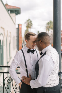 LGBTQIA couple smiling together on the balcony at Hotel Haya in Ybor City Tampa Florida