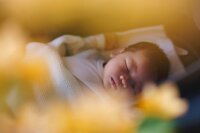 A newborn baby sleeps peacefully.