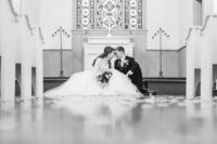 bride and groom sitting on church alter ohio wedding photographer