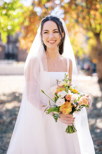 Maids of honor hug bride at Glen Foerd Estate in Philadelphia, PA