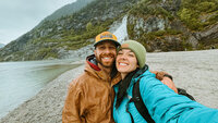 couple smiling with Nugget Falls in the back