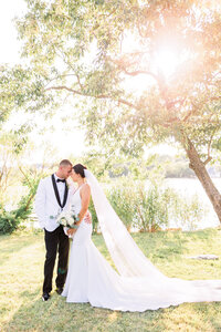 A bride and groom sharing an intimate moment, gazing at each other with love and connection.