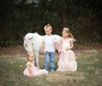 Siblings with gorgeous white unicorn dressed up