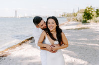 couple smiling and laughing on beach