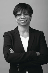 Close-up black and white image of woman standing in front of a seamless backdrop