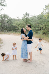 Family of five walks on a dock at their home
