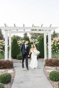 Photo of Bride and Groom holding hands.