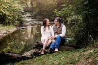 Couple sitting along a stream at Frontier Park
