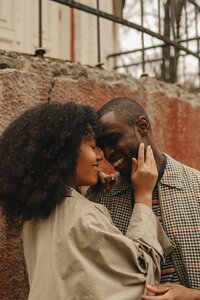 A black man and woman embrace, representing the value of inclusivity and diversity at the Crush Collective wedding expo.