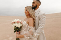 Bride and groom during their intimate Michigan wedding in the sand dunes