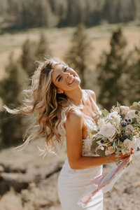 bride smiling holding her bouquet of flowers
