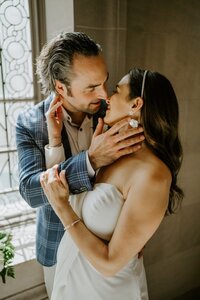 bride and groom kissing on mountain