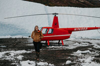 woman standing in front of helicopter