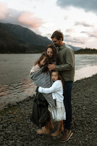 Family of four on river bank
