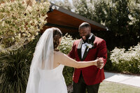 A wedding couple smiles at one another during a First Look.