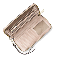 A pink wallet by Michael Kors with lots of slots, an ID window, and a zippered change pouch.