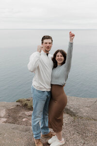 A couple standing together cheering 