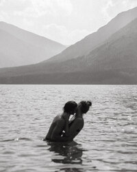 couple hugging in the water in Banff