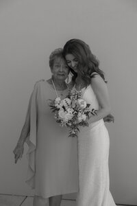 bride's parents hugging bride