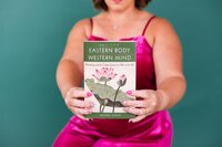 Therapist holding book, "Eastern Body Western Mind"