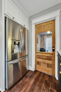 Stainless steel refrigerator in this three-bedroom, two-bathroom vacation rental home featured on Chip and Joanna Gaines' Fixer Upper located in downtown Waco, TX.