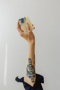 a woman's hand holding a bar of soap