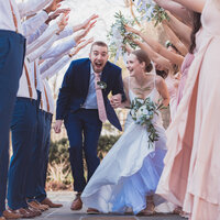 Couple runs through bridal party and groomsmen at a Hampton Roads Virginia Wedding