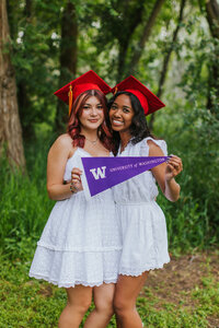 Two senior girls in caps smiling Tri Cities photographer