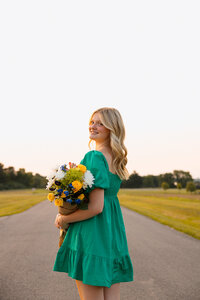 man lifts up fiance during engagement photoshoot