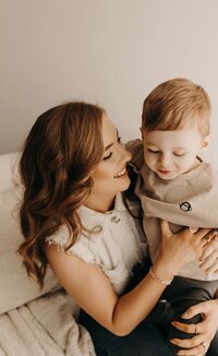 Heartwarming portrait of a mother lovingly holding her young child in a Mullingar studio