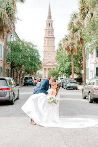 Bride & Groom shares a dip and kiss in front of St Philips Church in the French quarter | Charleston-SC | Captured by Kara Blakeman Photography