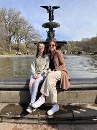 Mom and daughter sitting at the fountain in Central Park.