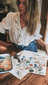 Image of east Coast stationery designer painting at workspace