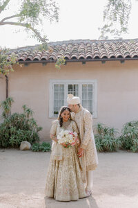 Bride and groom snuggle on their Santa Barbara Historical Museum wedding day