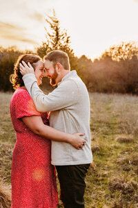man holding his fiances face as he is about to kiss her for engagement session