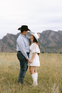 the couple is enjoying their mountainous view during their engagement photos in colorado