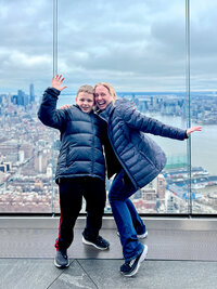 Kelly Loss and her son stand on the edge of a skyscraper