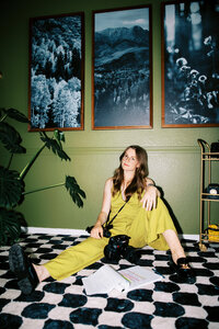 woman sits on floor with super 8 cameras