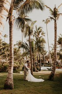 groom holding bride in desert