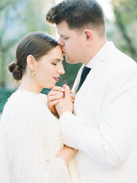 groom kissing his bride on the forehead