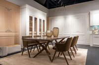 Elegant dining room with a large table and chairs.