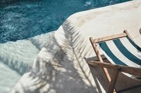 Beach chair next to a pool