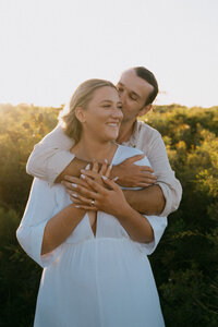 Bride and groom hugging at sunset at their Newcastle elopement