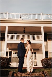 bride and groom gazing into each other eyes on the top of stone steps of a historic home in Upstate