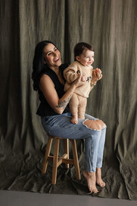 A joyful moment of a mother with her toddler in a warm, natural studio setting, captured by a Cleveland family photographer.