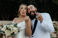 Bella Rose Estate Wedding Photographer and Videographer Couple Showing Off Ring Fingers with Silly Faces