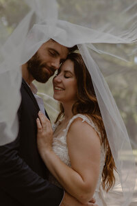 wedding couple underneath the veil