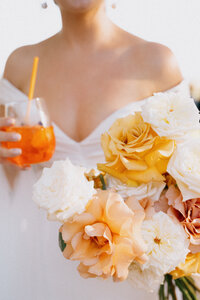 Bride holding flowers and a cocktail at her Hunter Valley wedding
